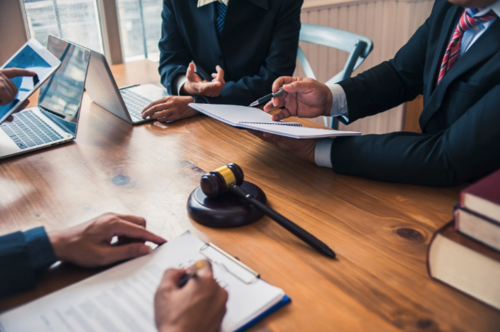 Advanced Legal Research attornies working with paperwork at desk