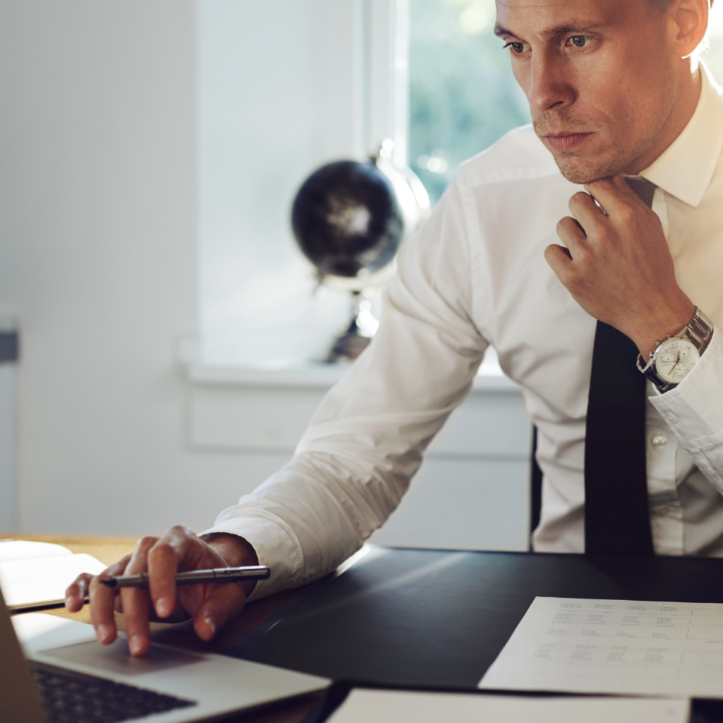 male attorney ion white button up shirt working in office