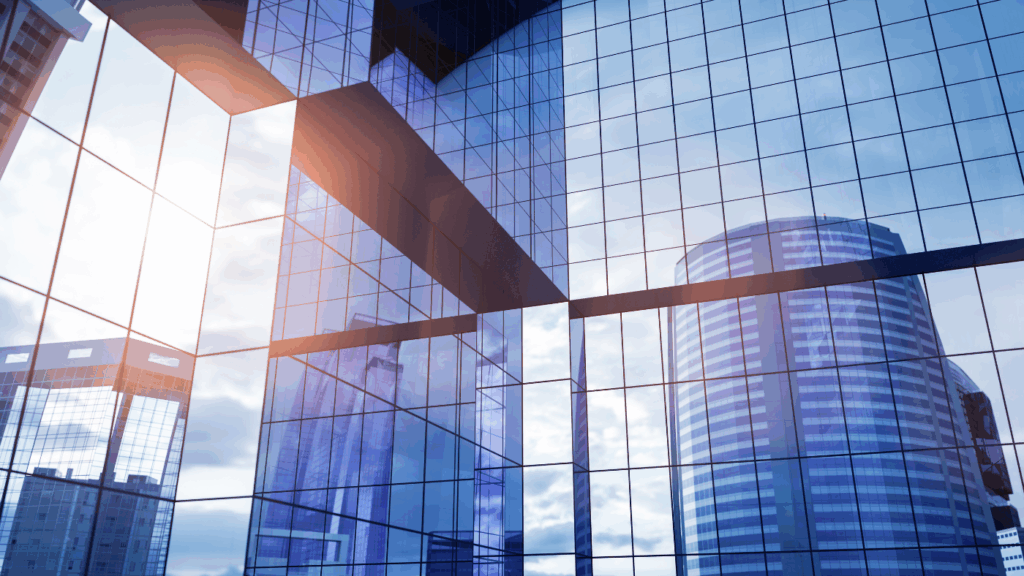 Mirrored skyscraper building in blue tones reflecting the sun