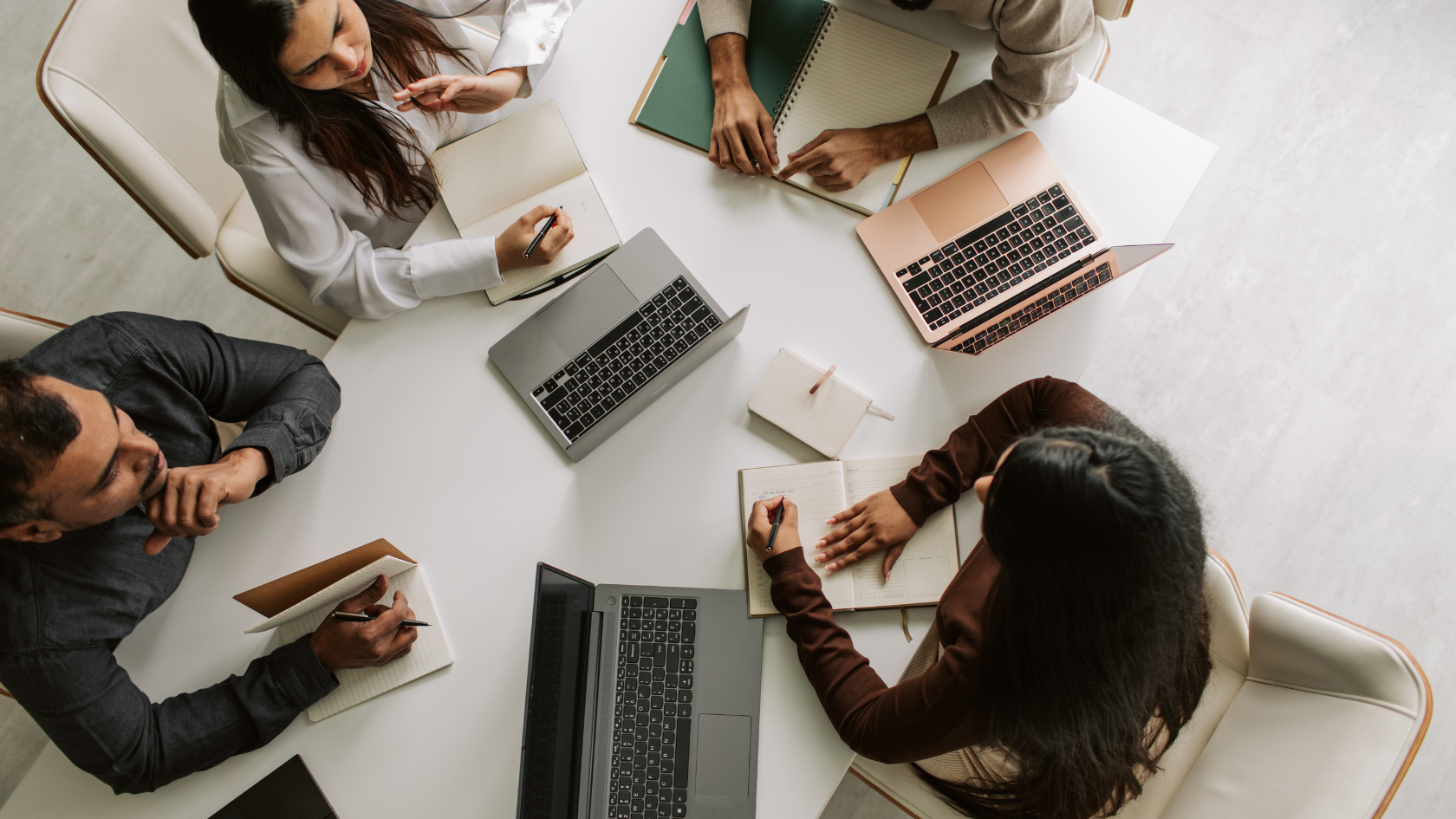 Students working on laptops at table