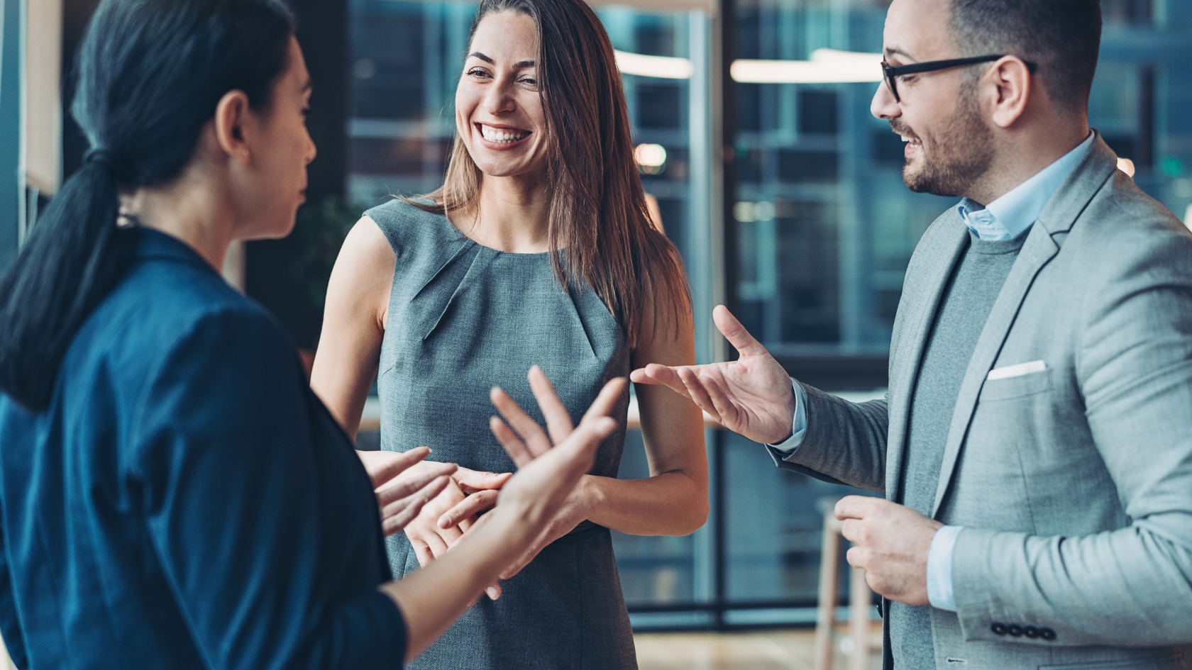 Group of business professionals chatting and networking in office space