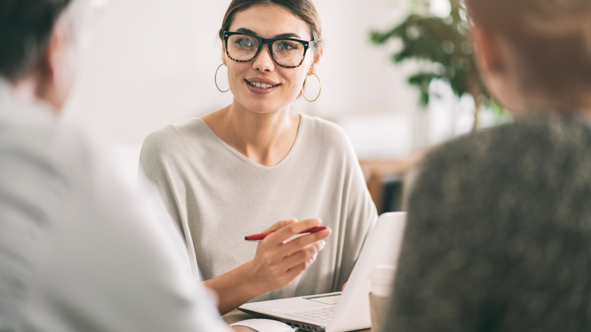 Female attorney working at desk with peers
