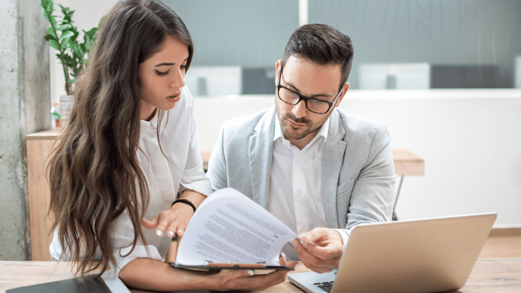 Two legal professionals reviewing California premarital agreement requirement documents