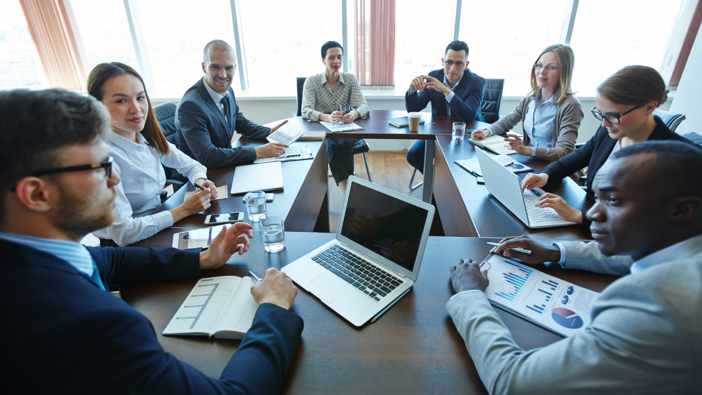 Group of legal professionals in a meeting on their laptops.