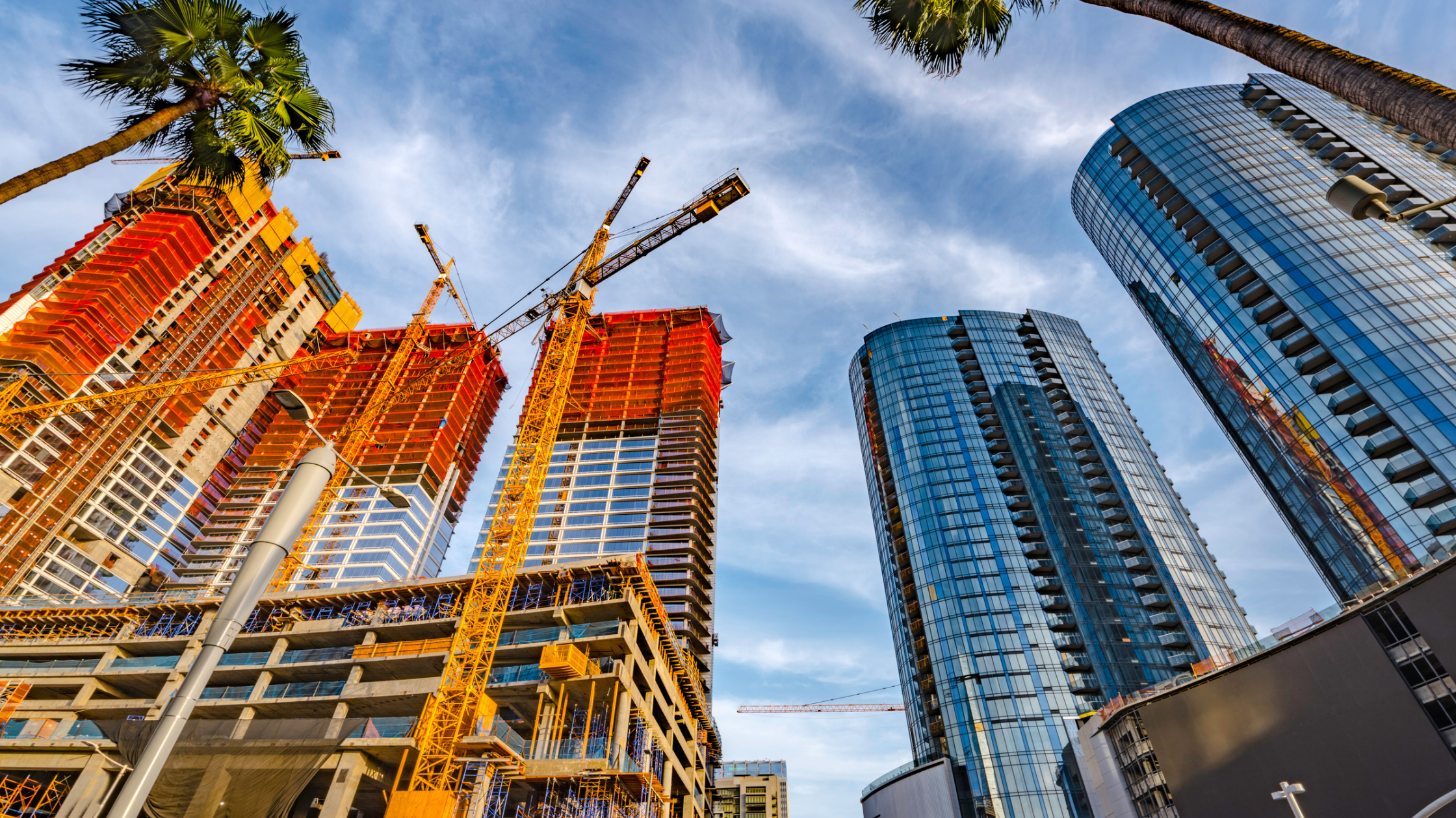 Downtown California construction with crane and palm trees