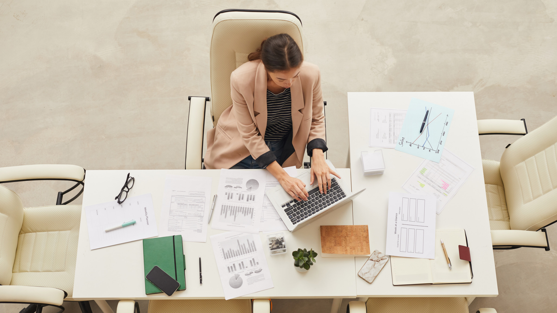 FEmale attorney working at desk with laptop and financial documents for need-based attorney fee award family law